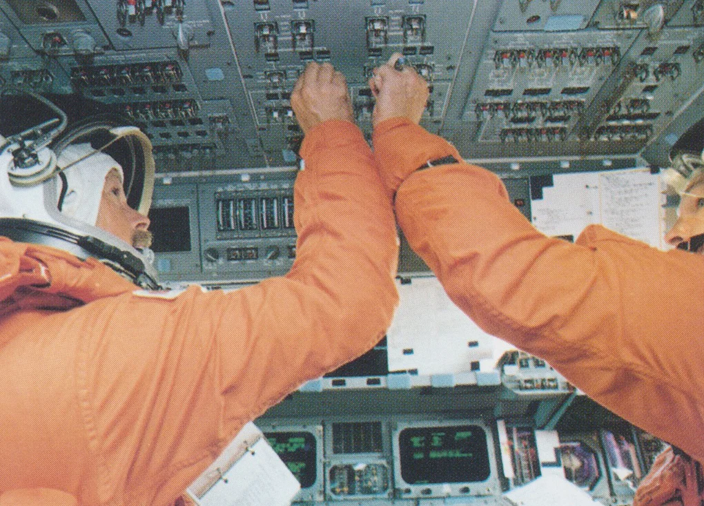 Astronauts at the Overhead Controls